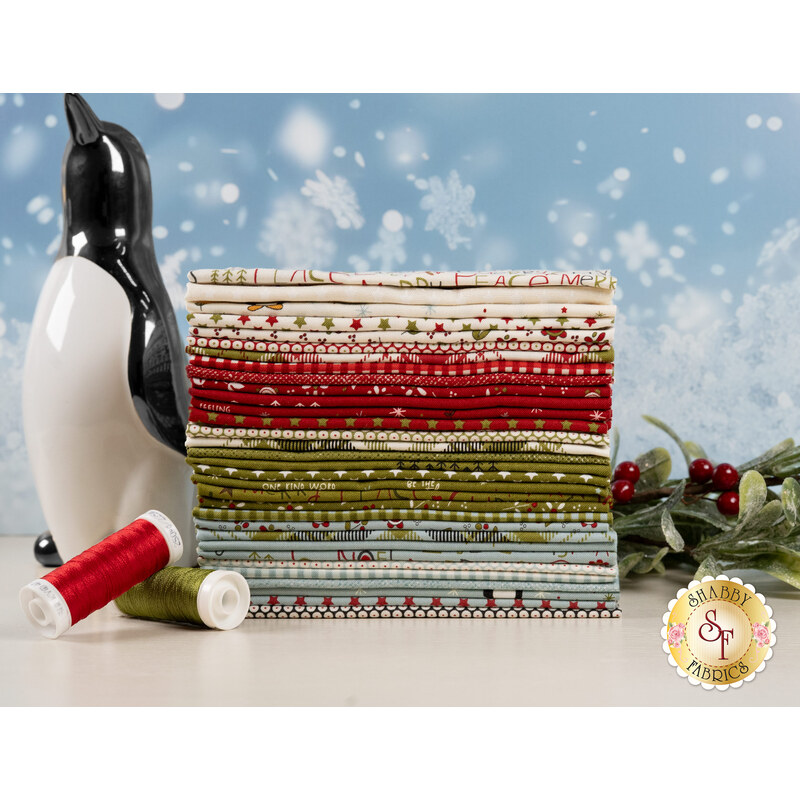 A stack of the fabrics included in the Chilly F8 set, with mistletoe and snow and a penguin and thread.