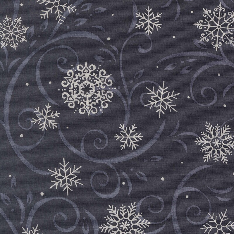 Midnight blue fabric with light indigo flourishes and white snowflakes