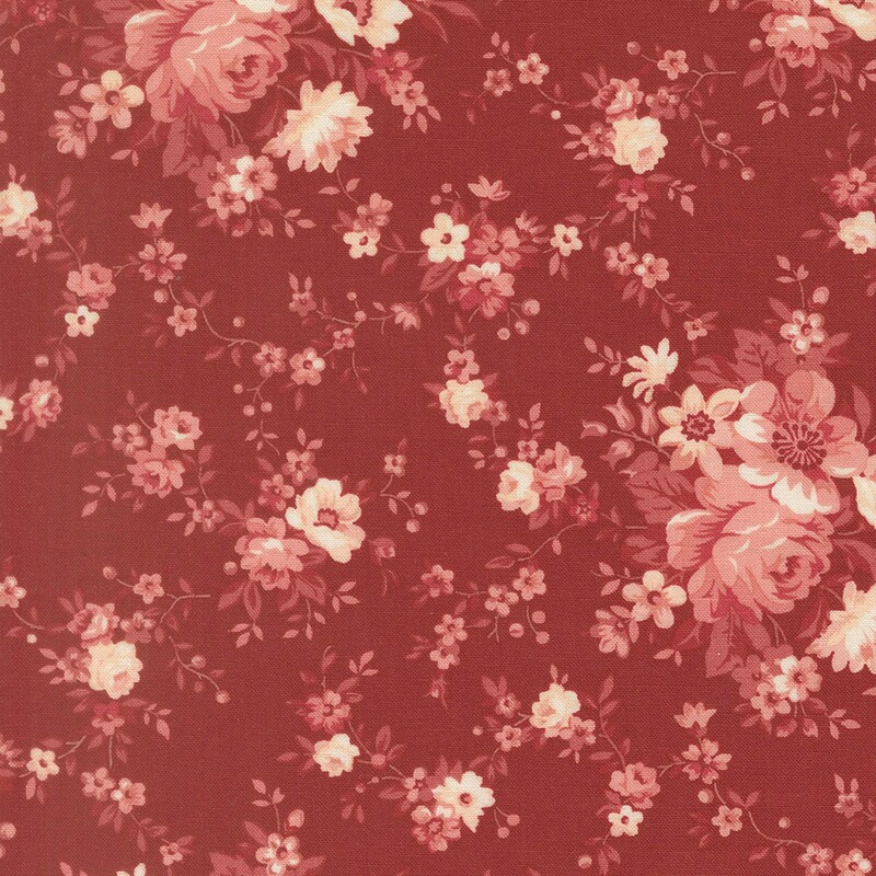A crimson fabric with a shabby pattern of muted vines, roses, and pink flowers in shades of muted pink
