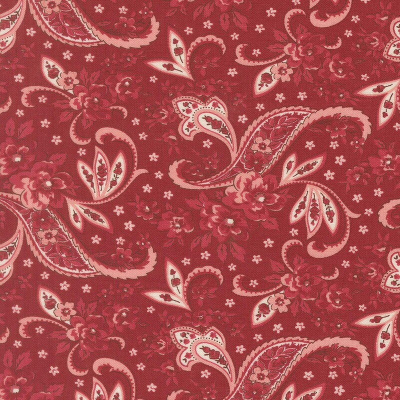 Cherry red fabric with a white, pink and crimson pink floral paisley design and small light pink flowers
