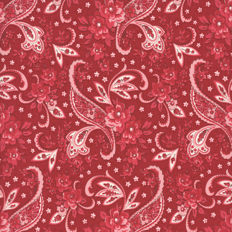 Cherry red fabric with a white, pink and crimson pink floral paisley design and small light pink flowers.