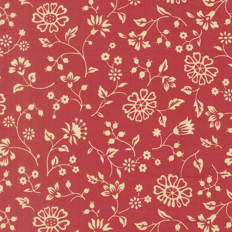 Watermelon red fabric with a spaced pattern of light cream beige florals and vines