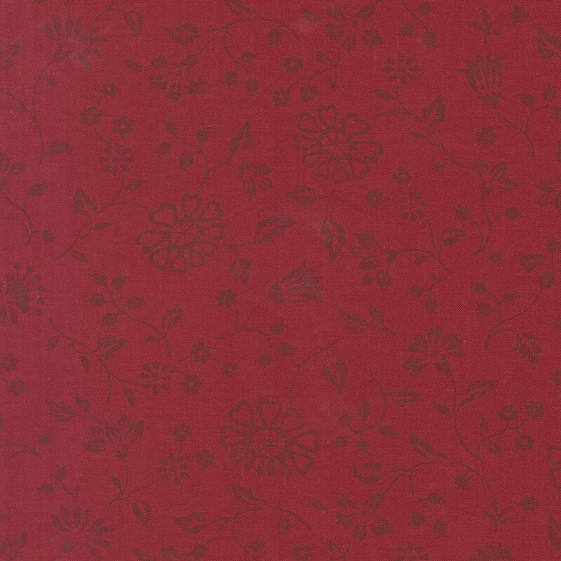 Crimson fabric with a spaced pattern of dark maroon florals and vines