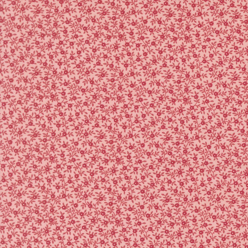 Coral fabric with a dense pattern of pink and magenta vines and flowers