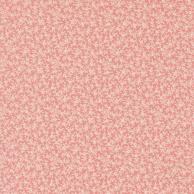 Blush pink fabric with a dense pattern of white vines and flowers