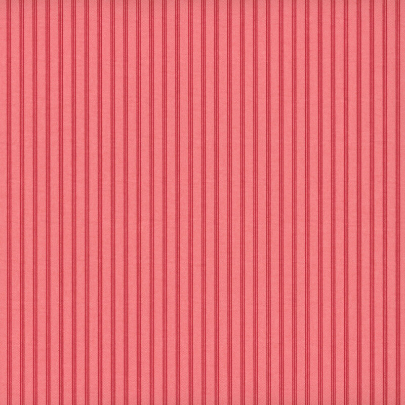 Vertical ticking stripes in watermelon red on salmon pink fabric.