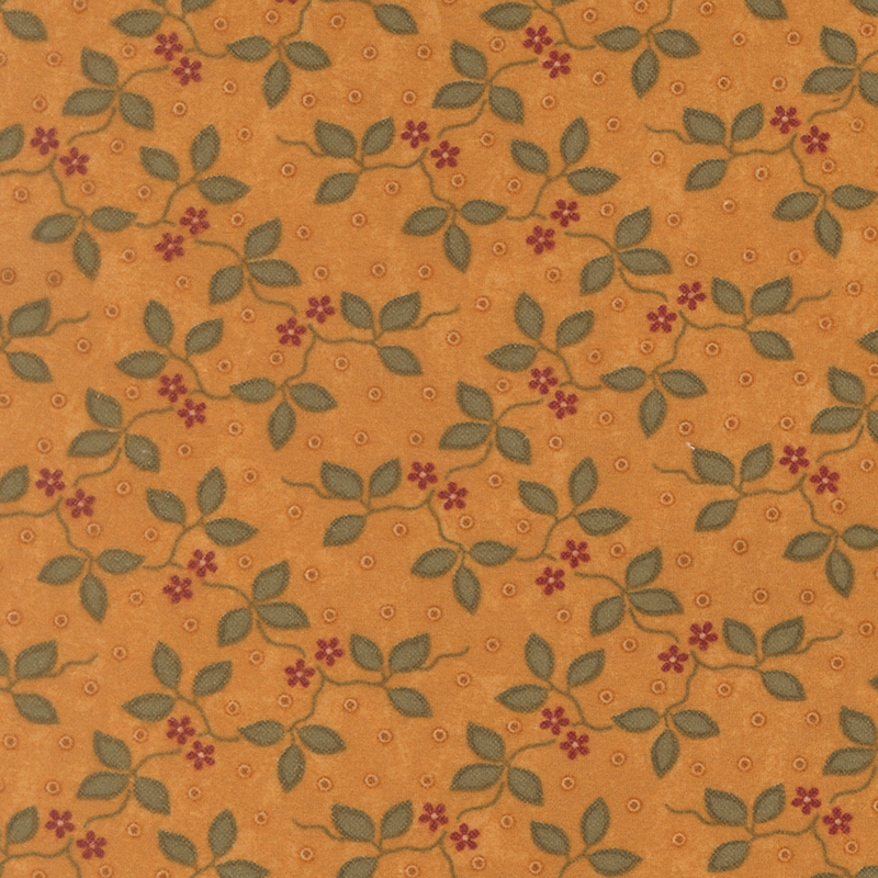 Dark gold flannel fabric featuring small red flowers and green vines on a dotted background.