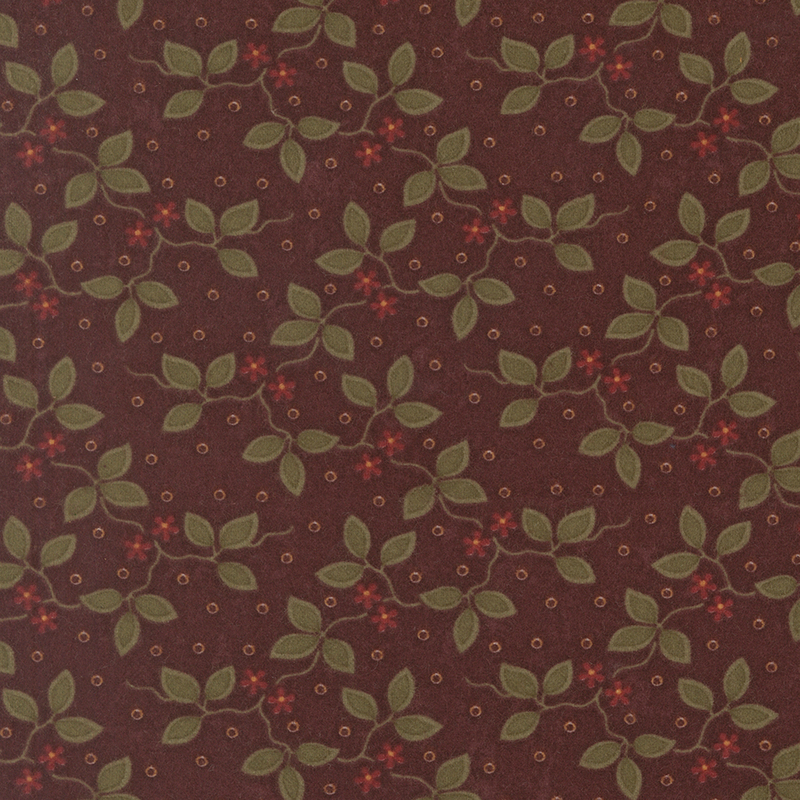 Mahogany flannel fabric featuring small red flowers and green vines on a dotted background.