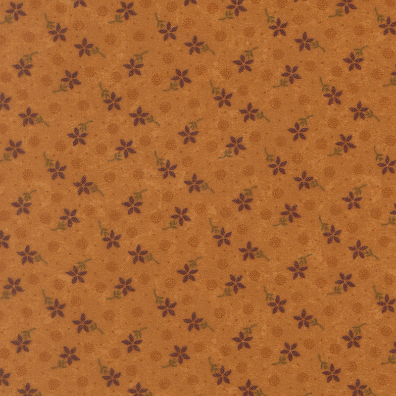 Flannel fabric featuring red flowers, pin dots, and pointillism circles tossed on a dark orange background.