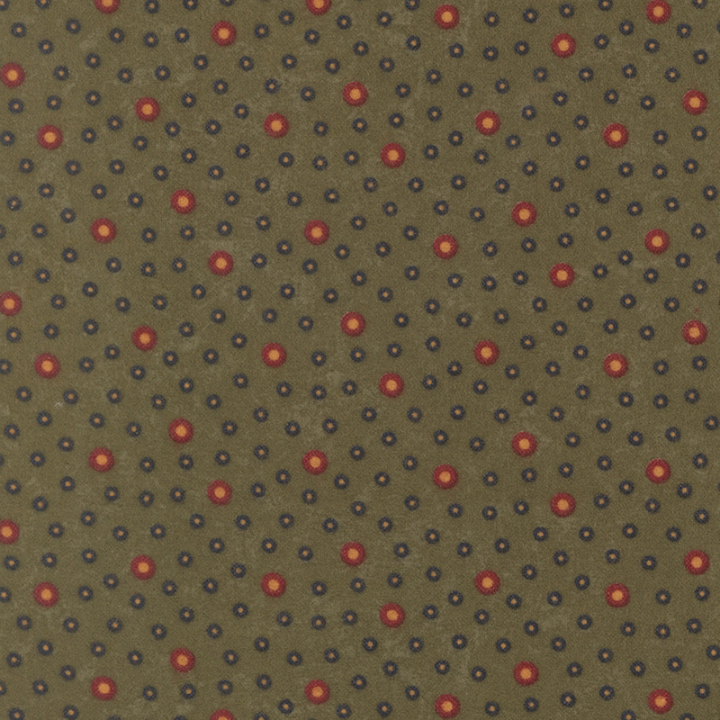 Flannel fabric featuring red and navy rings with tan centers tossed on a muted dark green background.