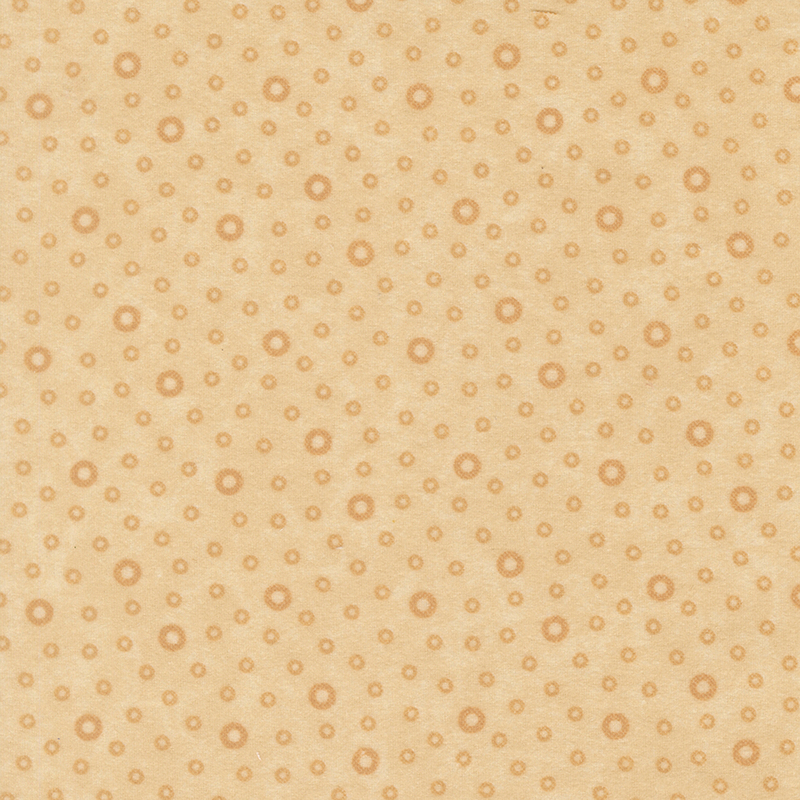 Flannel fabric tossed with tonal tan rings.