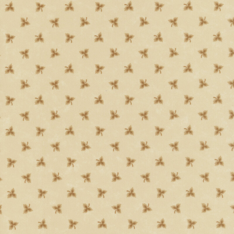 Maple leaf shadows tossed on tonal tan flannel fabric.