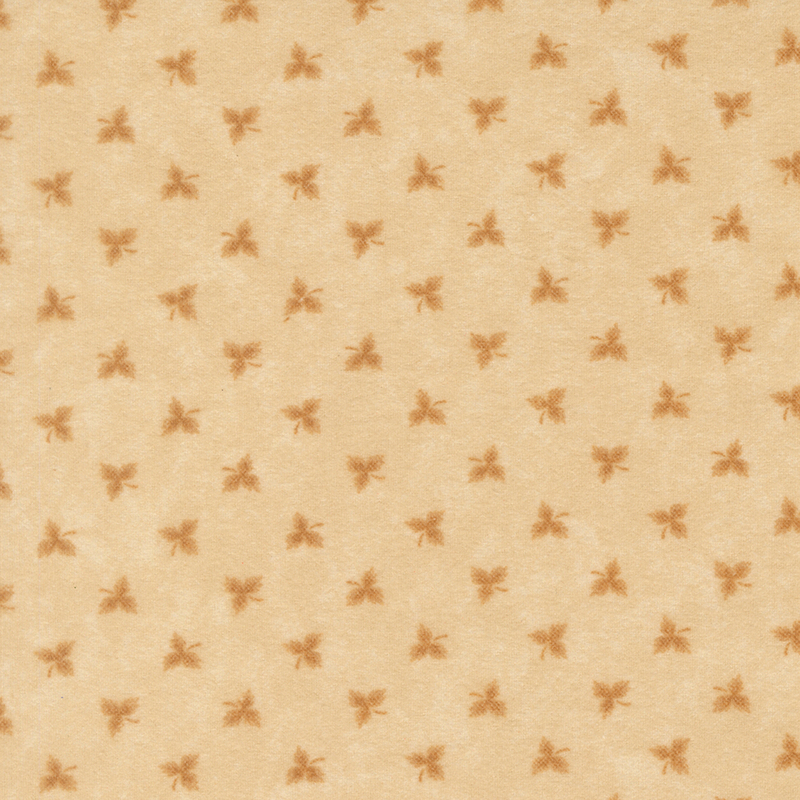 Maple leaf shadows tossed on tonal tan flannel fabric.