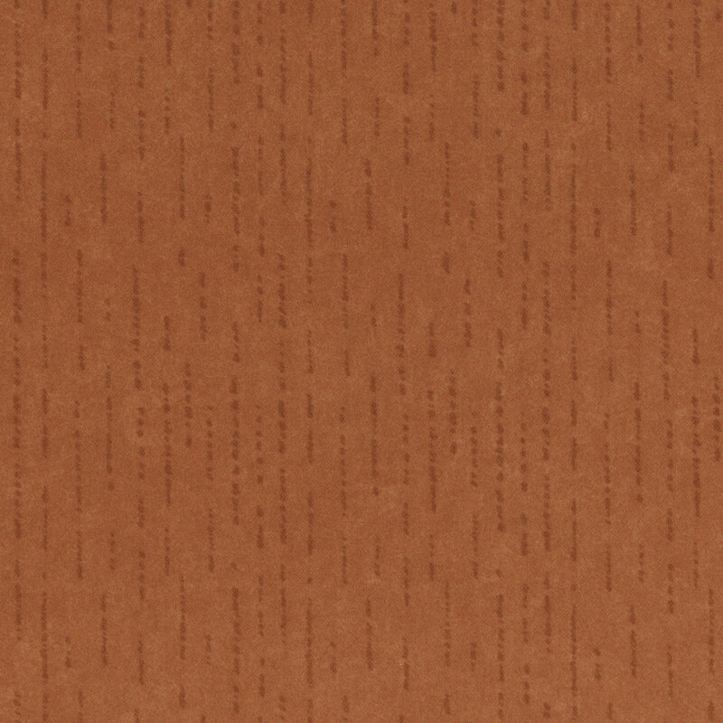 Tonal dark orange flannel fabric with dashed and dotted lines.