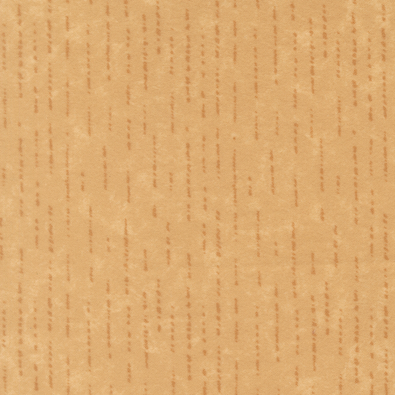 Tonal tan flannel fabric with dashed and dotted lines.