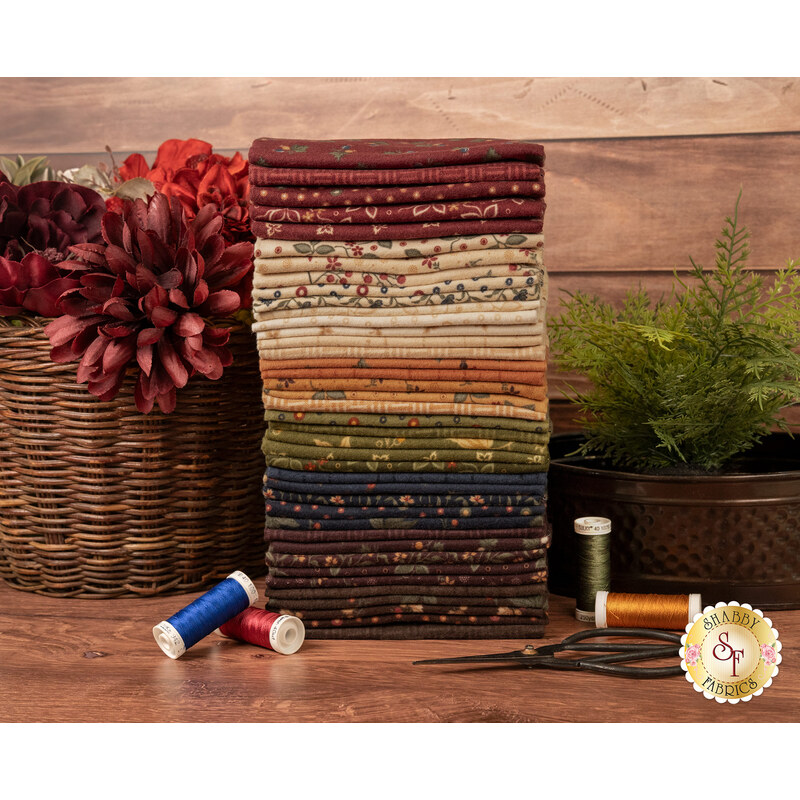 A stack of the fabrics included in the Flannel Season F8 set, with flowers and plants and baskets and scissors and thread.