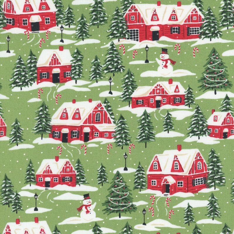 Muted green fabric featuring red cottages, evergreen trees, and snowmen dusted with snow and decorated with candy canes.
