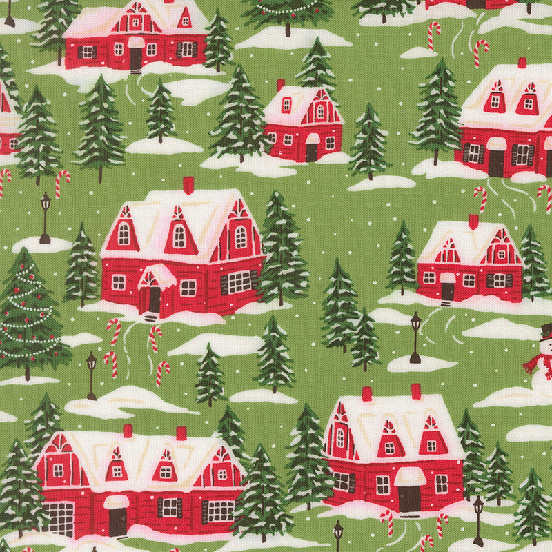 Muted green fabric featuring red cottages, evergreen trees, and snowmen dusted with snow and decorated with candy canes.