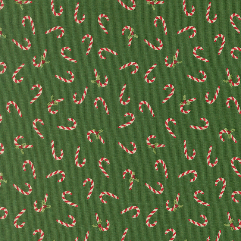 Red and white striped candy canes and holly tossed on a dark green background.