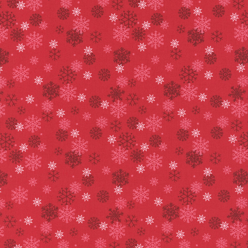 White and tonal snowflakes tossed on a cranberry red background.