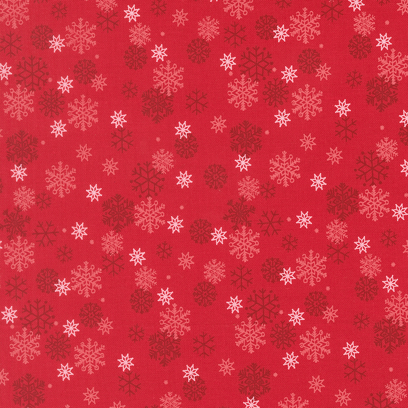 White and tonal snowflakes tossed on a cranberry red background.