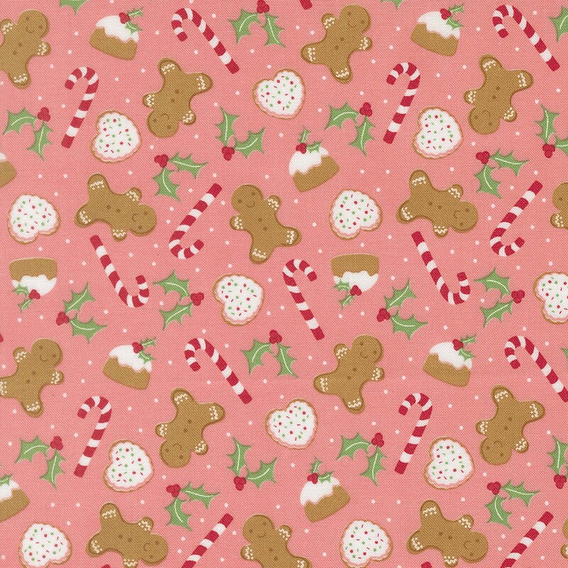 Salmon pink fabric with candy canes, holly leaves, gingerbread men, and other baked goods