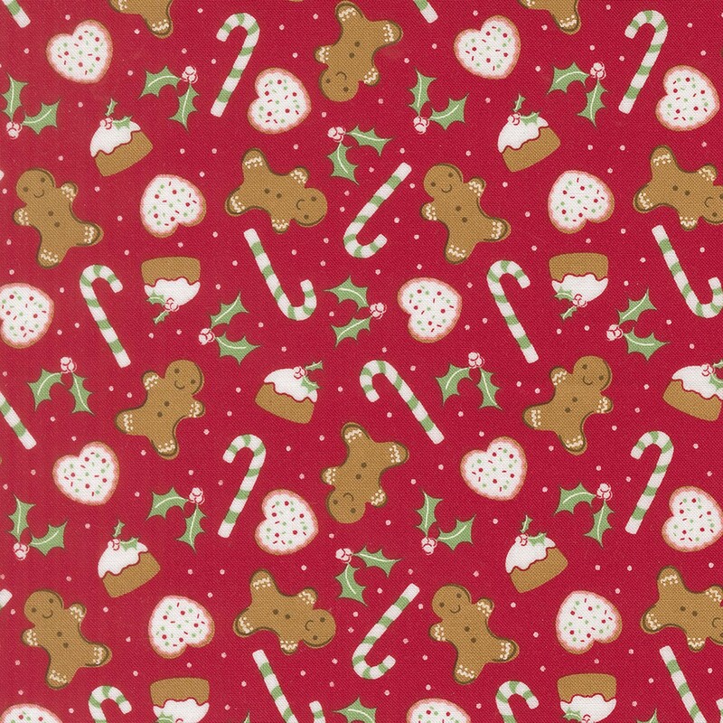 Cranberry red fabric with candy canes, holly leaves, gingerbread men, and other baked goods
