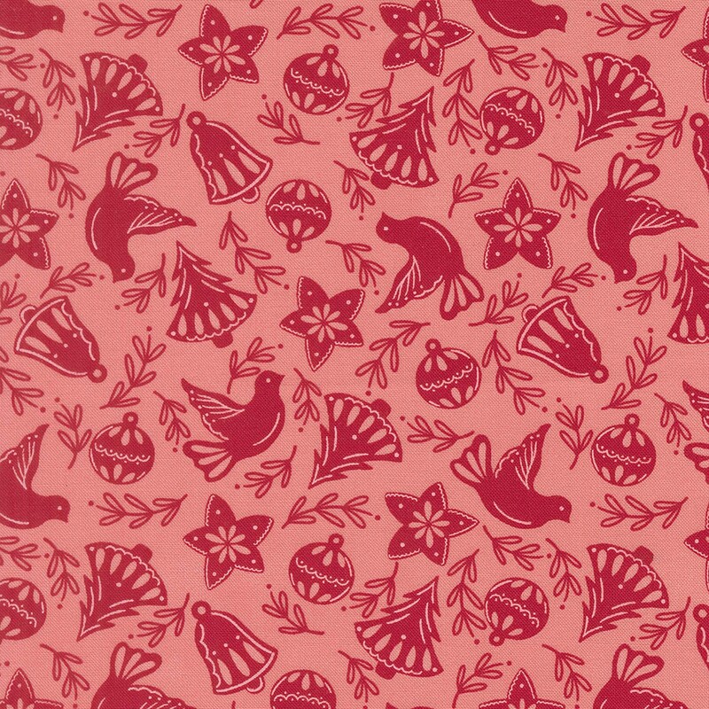 Salmon pink fabric with red Christmas trees, bells, leaves, stars, ornaments, and doves