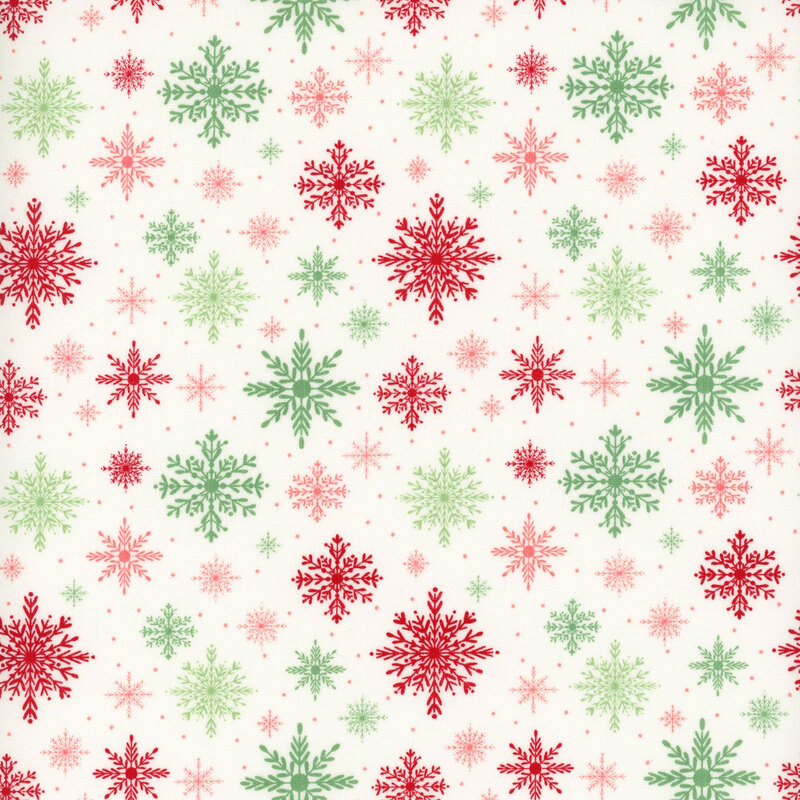 White fabric with a pattern of red, pink, and green snowflakes in various sizes
