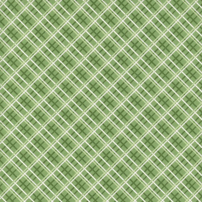 Medium green fabric with a dark green, light green, and white diagonal windowpane plaid pattern