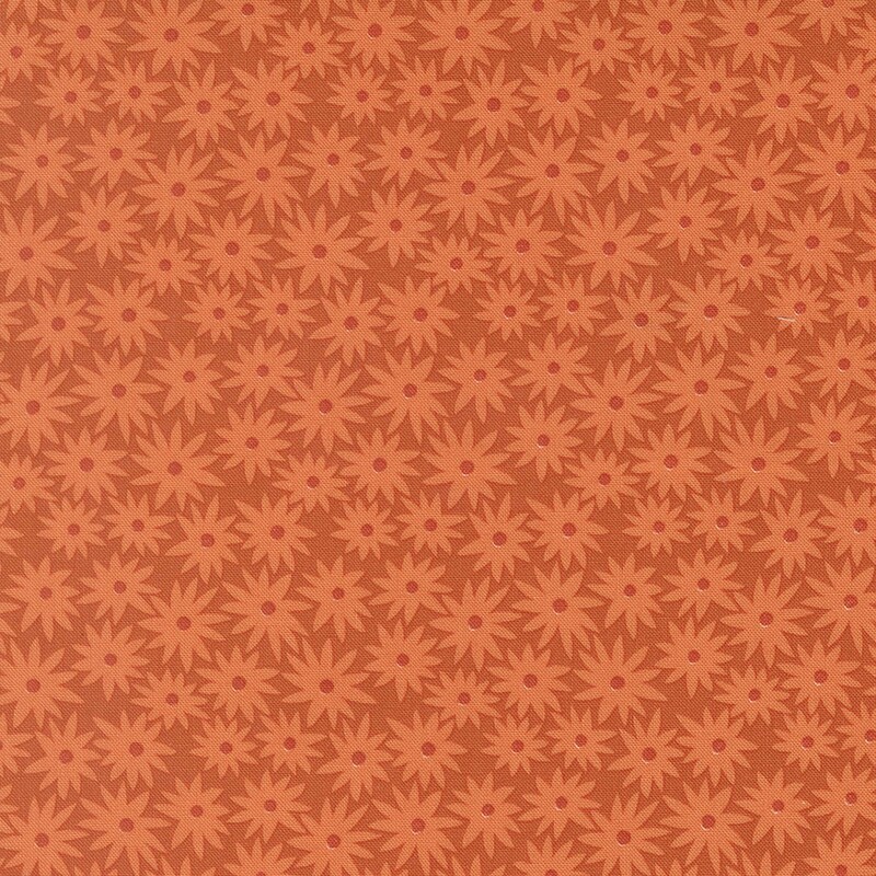 Pumpkin orange fabric with light orange daisies in a dense pattern