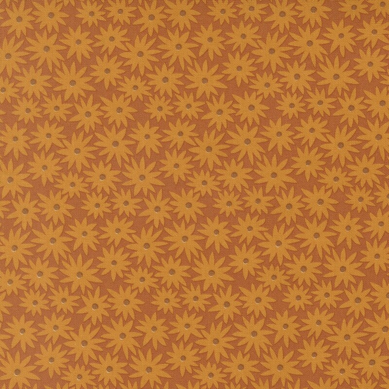 Cinnamon colored fabric with butterscotch daisies in a dense pattern