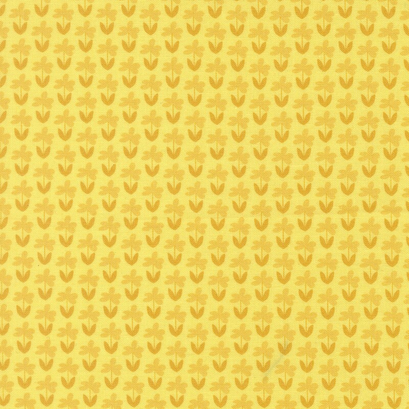 Sunshine yellow fabric with a pattern of little gold florals and butterscotch stems