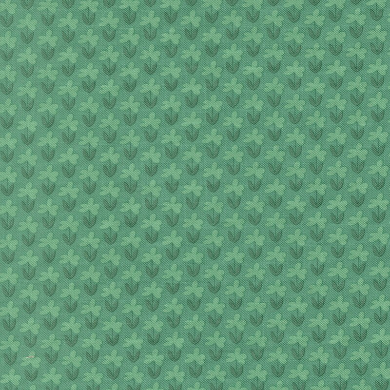 Bright jade fabric with a pattern of little mint green florals and teal stems