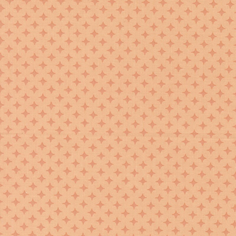 Light peach fabric with a geometric pattern of apricot orange diamonds 