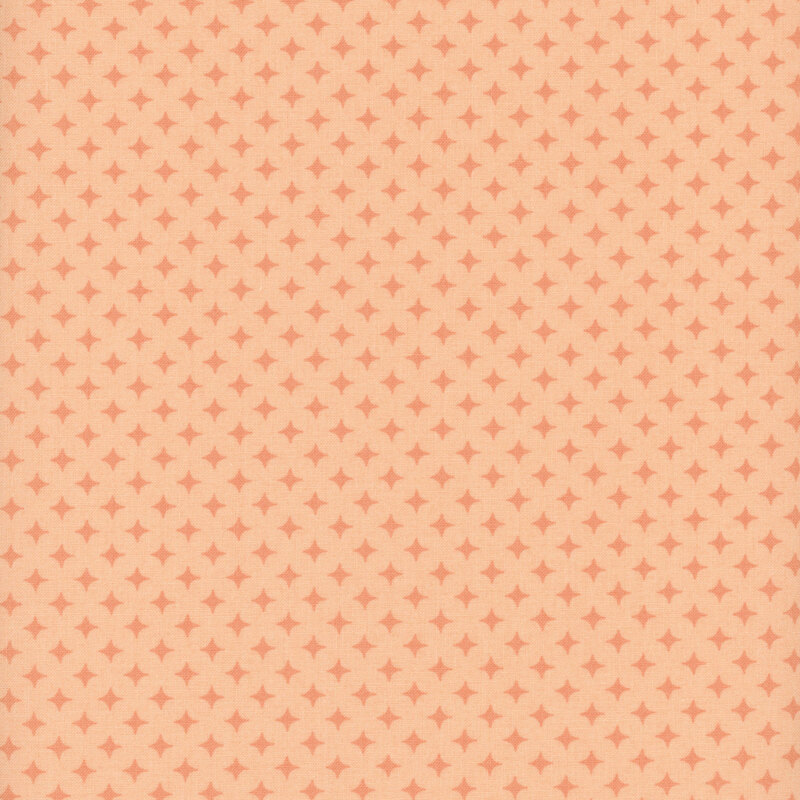 Light peach fabric with a geometric pattern of apricot orange diamonds 