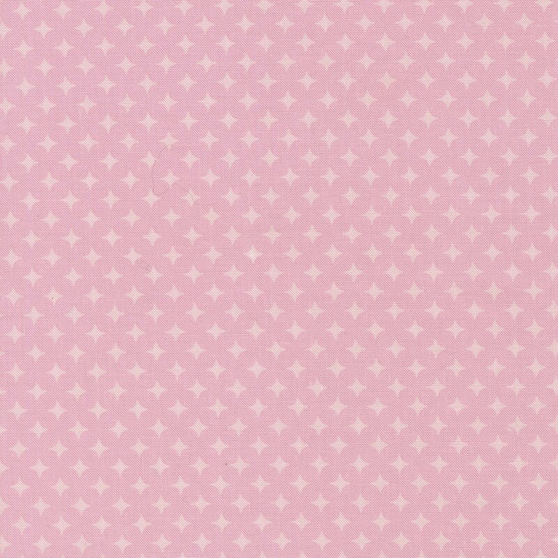 Ballet pink fabric with a geometric pattern of pastel pink diamonds 