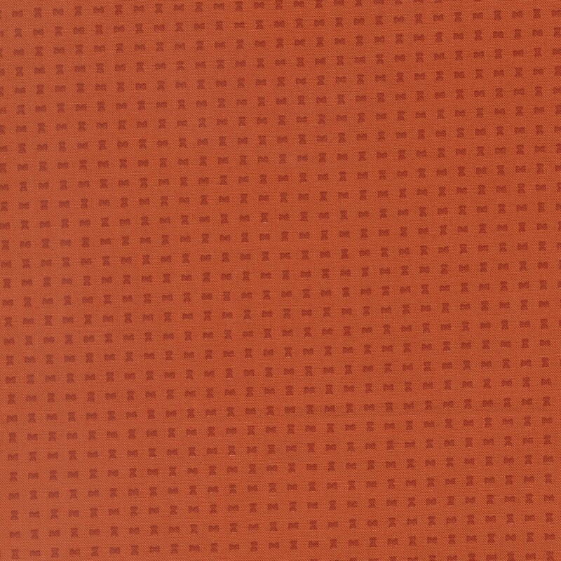 Small russet orange hourglass shapes on an auburn background
