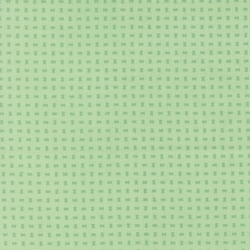 Small jade green hourglass shapes on a pistachio green background