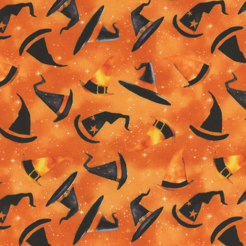 Decorated pointed hats tossed on a mottled orange and starry background.