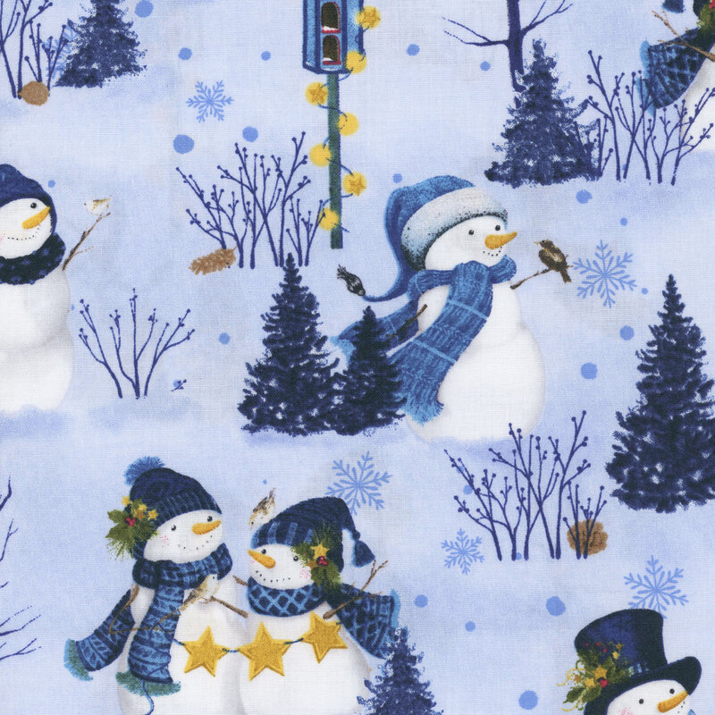 Light blue fabric featuring a winter scene with snowmen dressed in scarves and hats, birds, holly, and snowflakes.