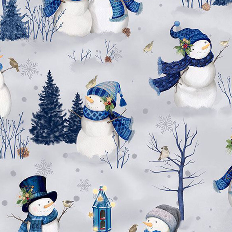 Gray fabric featuring a winter scene with snowmen dressed in scarves and hats, birds, holly, and snowflakes.