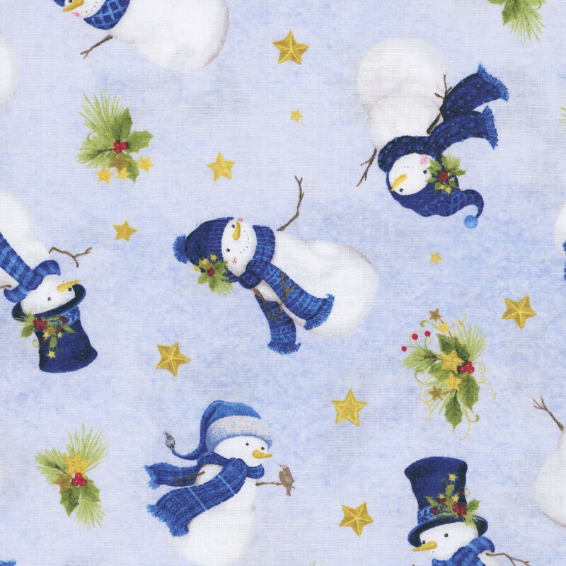 Snowmen in scarves and hats tossed with stars and holly sprigs on mottled light blue fabric.