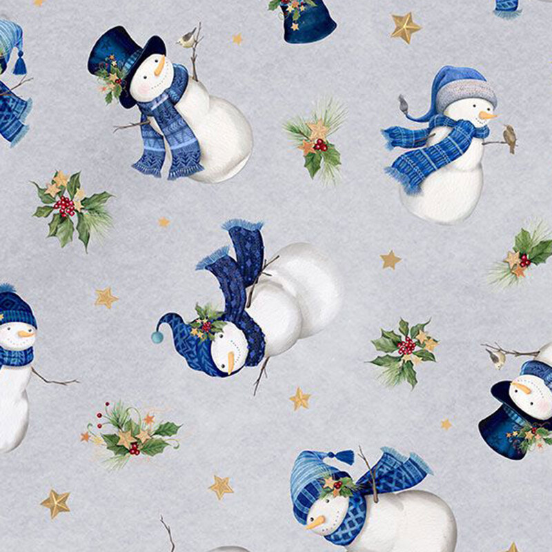 Snowmen in scarves and hats tossed with stars and holly sprigs on mottled light light fabric.