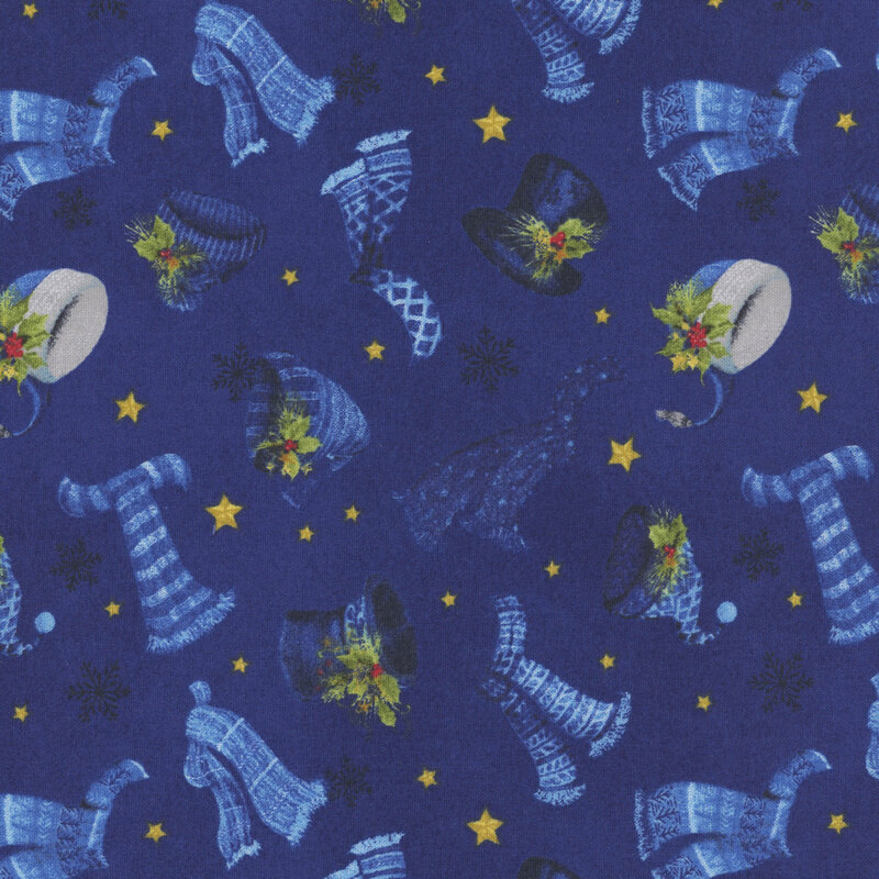 Mottled navy blue fabric tossed with warm winter hats, scarves, sprigs of holly, stars, and snowflakes.