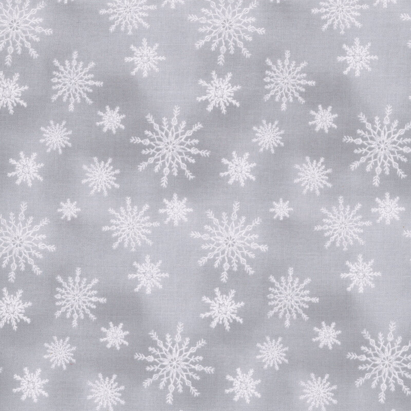 White snowflakes tossed on a mottled light gray background.