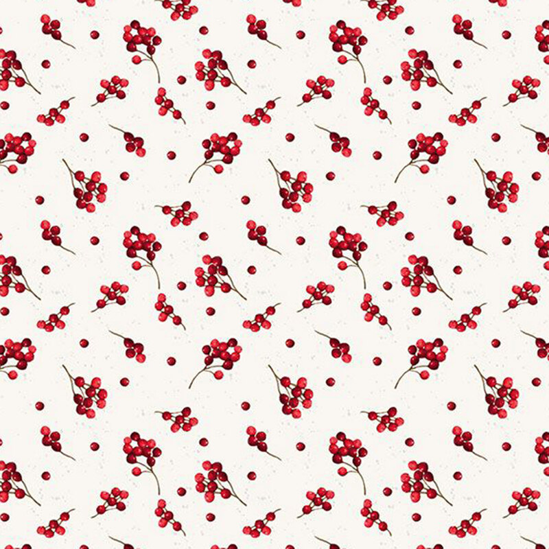 Sprigs of holly berries tossed on a light cream background.