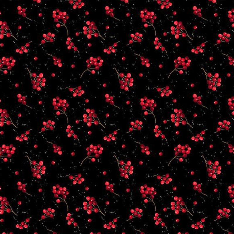 Sprigs of holly berries tossed on a black background.
