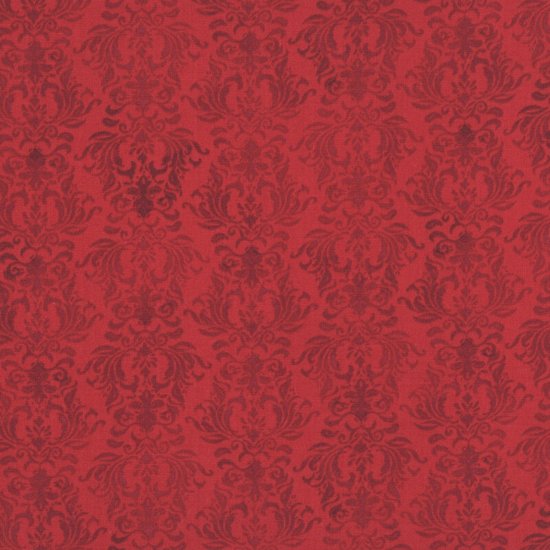 Red fabric with a tonal damask design.