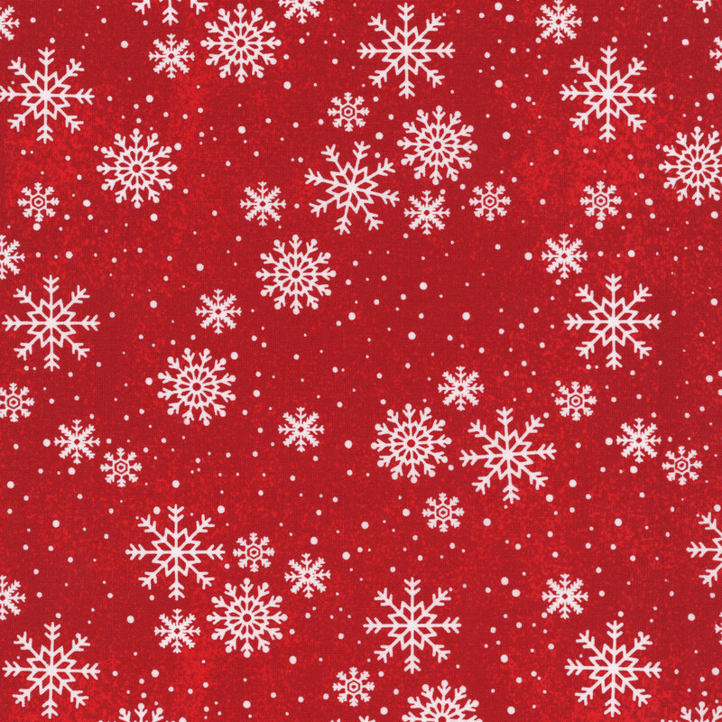 Delicate white snowflakes tossed on red fabric.